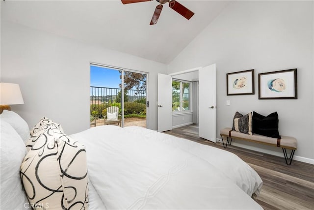 bedroom with access to outside, high vaulted ceiling, wood finished floors, and baseboards