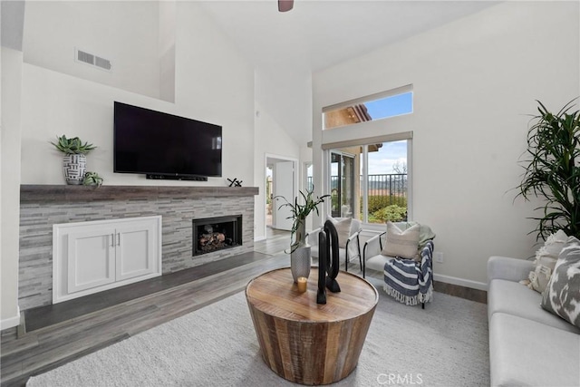 27557 Paseo Tamara, San Juan Capistrano, CA 92675 - living room with a tile fireplace, wood finished floors, high vaulted ceiling, visible vents, and baseboards