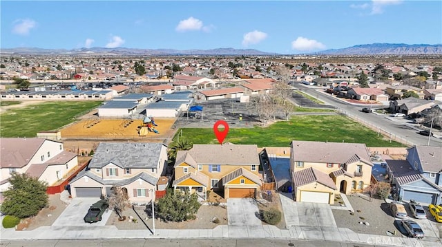 drone / aerial view featuring a residential view and a mountain view