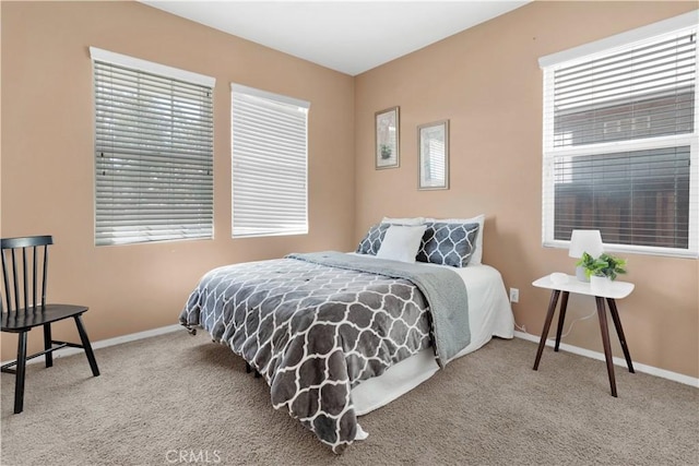 carpeted bedroom featuring baseboards