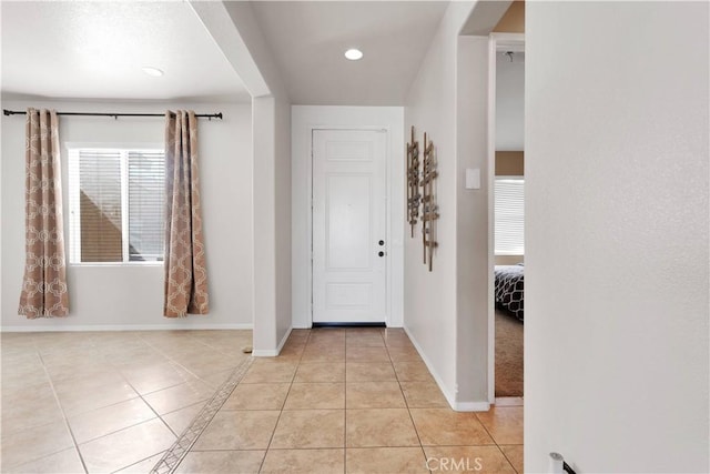 entryway featuring light tile patterned floors, recessed lighting, and baseboards