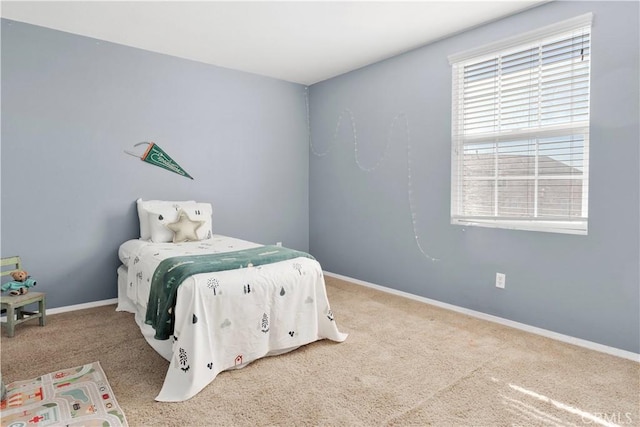 bedroom featuring carpet floors and baseboards