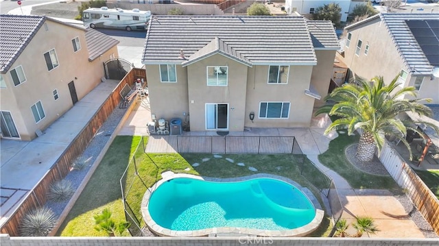 view of pool with a yard, a fenced in pool, a fenced backyard, and a patio