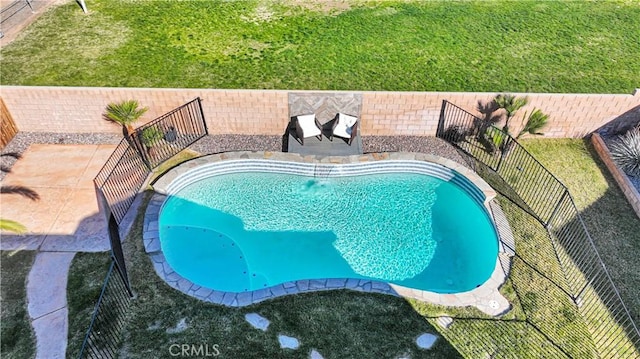 view of swimming pool with a fenced in pool, a fenced backyard, and a patio