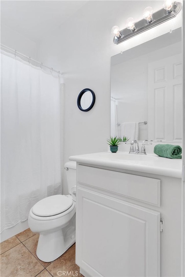 bathroom featuring vanity, toilet, and tile patterned floors