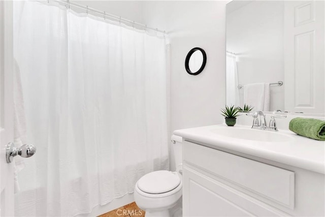 bathroom featuring toilet, shower / tub combo with curtain, and vanity