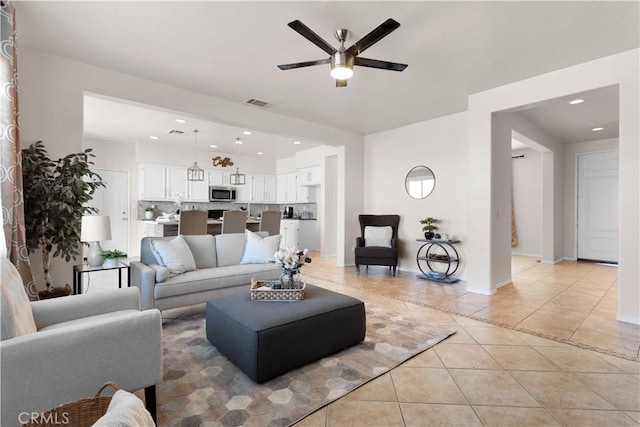 living area featuring recessed lighting, visible vents, ceiling fan, and light tile patterned floors