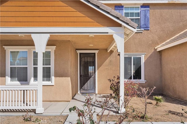 view of exterior entry featuring stucco siding