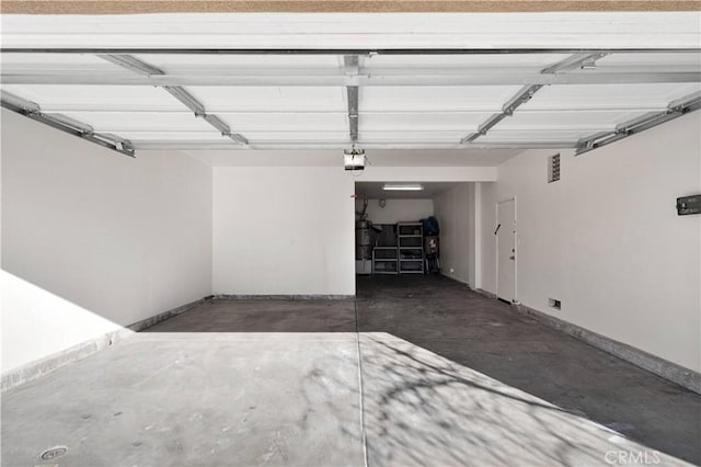 garage featuring baseboards and a garage door opener