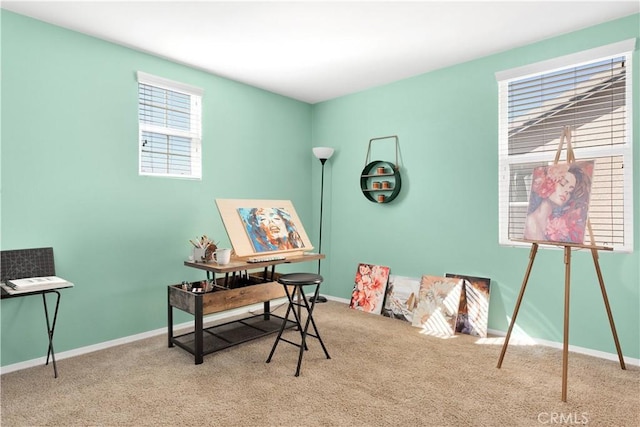 carpeted home office featuring baseboards