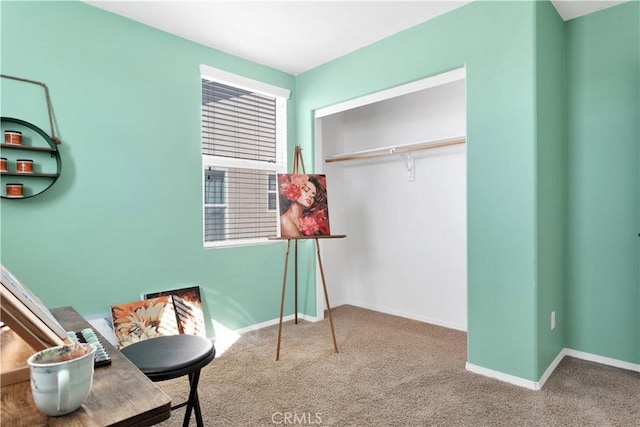 sitting room featuring carpet and baseboards