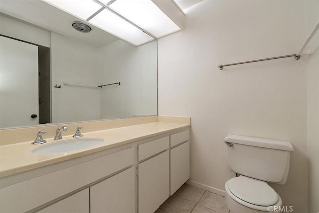 bathroom featuring toilet, vanity, and tile patterned floors