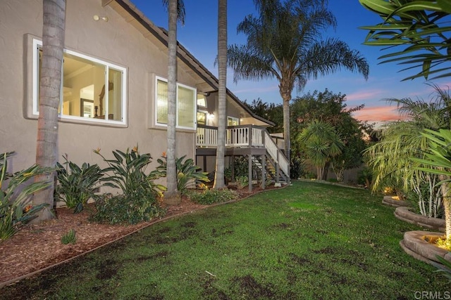 view of yard featuring stairs and a deck