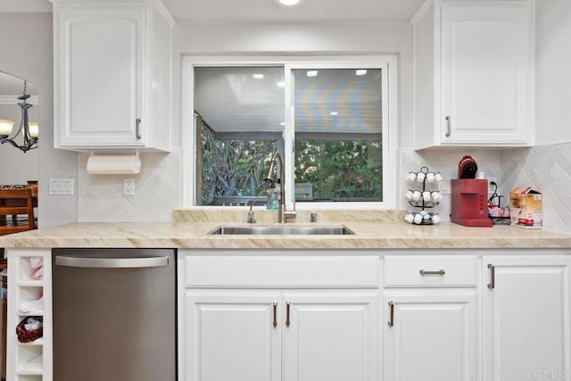 kitchen with white cabinets, light countertops, dishwasher, and a sink