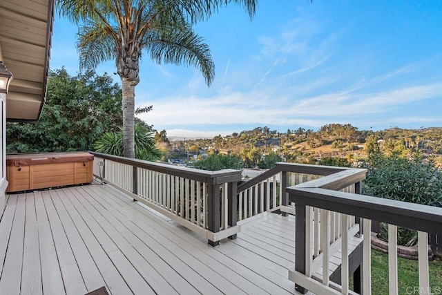 wooden deck featuring a hot tub