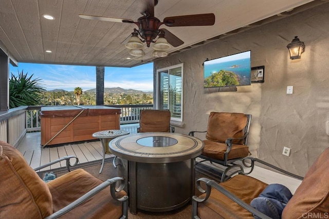 interior space with ceiling fan, wooden ceiling, recessed lighting, wood finished floors, and a wall of windows