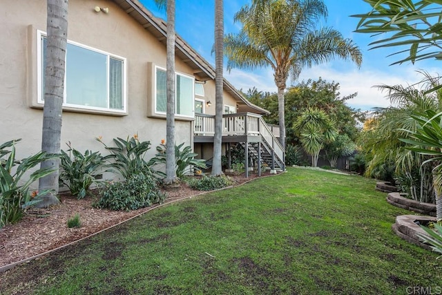 view of yard with a wooden deck and stairs