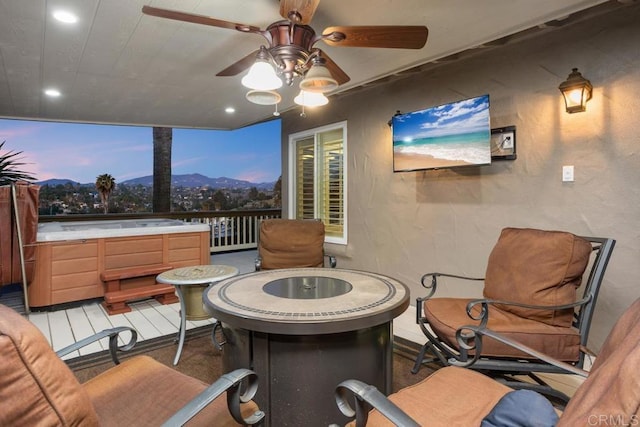 view of patio / terrace with a ceiling fan and a hot tub