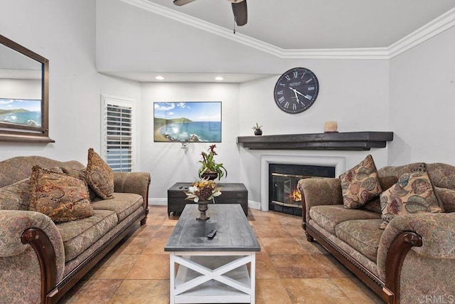 living area with ceiling fan, ornamental molding, a glass covered fireplace, and baseboards