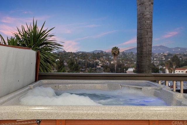 exterior space featuring a hot tub and a mountain view