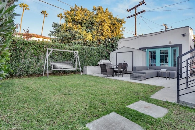 view of yard featuring an outbuilding, a patio, a storage shed, fence, and an outdoor living space