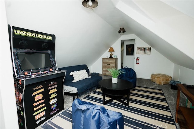 interior space with vaulted ceiling and carpet