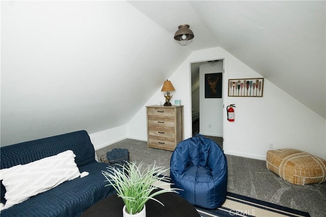 living area featuring carpet floors, baseboards, and lofted ceiling