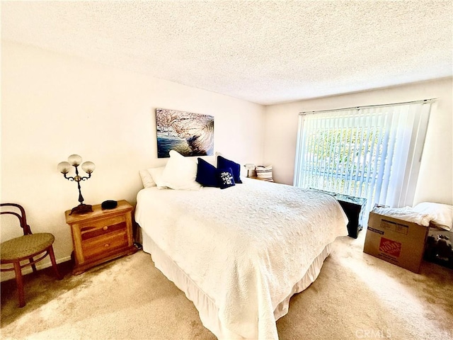 bedroom with a textured ceiling and carpet flooring