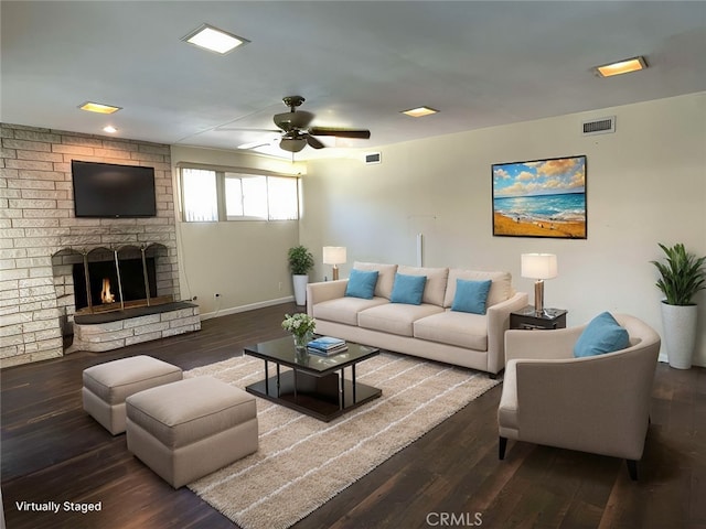 living room with visible vents, a ceiling fan, wood finished floors, a fireplace, and baseboards