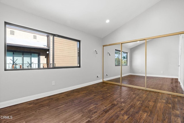 unfurnished bedroom with dark wood finished floors, lofted ceiling, a closet, recessed lighting, and baseboards