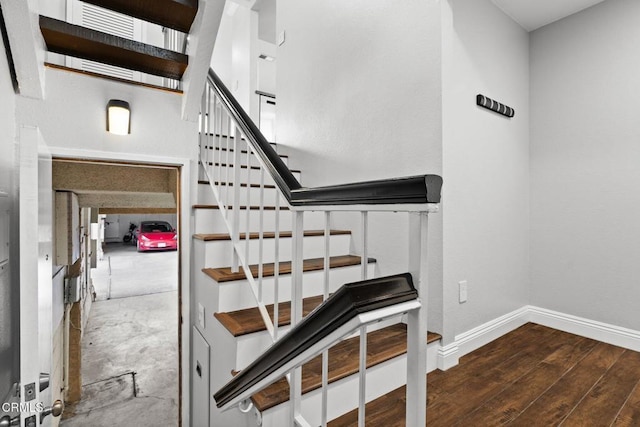 staircase with wood finished floors and baseboards