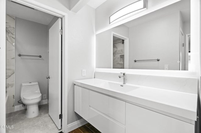 full bath with toilet, baseboards, and vanity