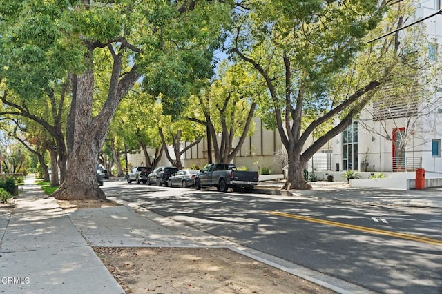 view of road with sidewalks and curbs