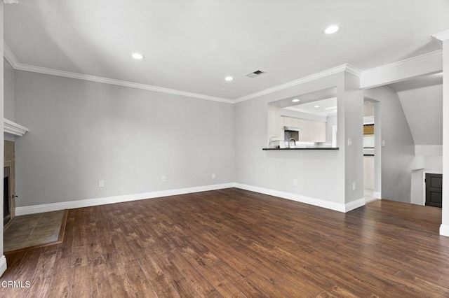 unfurnished living room with visible vents, a fireplace, baseboards, and wood finished floors