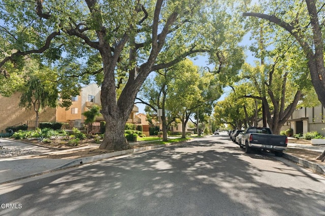 view of road featuring a residential view, curbs, and sidewalks