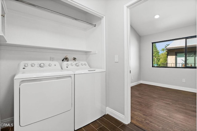 washroom with laundry area, dark wood finished floors, washer and clothes dryer, and baseboards