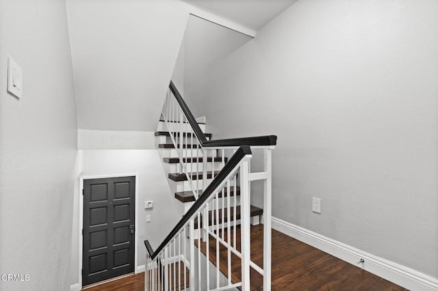 stairway with baseboards and wood finished floors