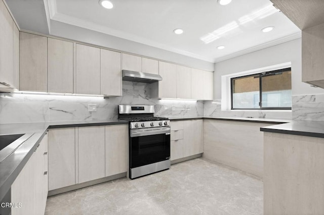 kitchen with under cabinet range hood, tasteful backsplash, stainless steel range with gas cooktop, and crown molding