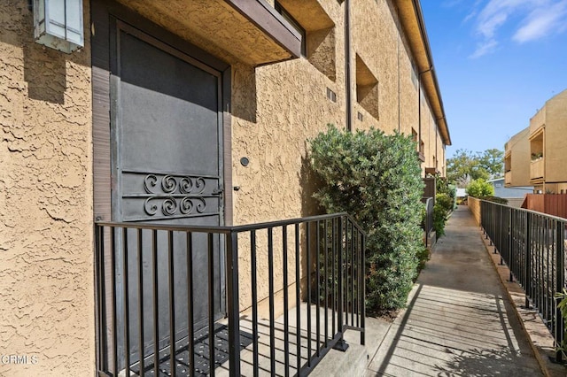 exterior space with fence and stucco siding