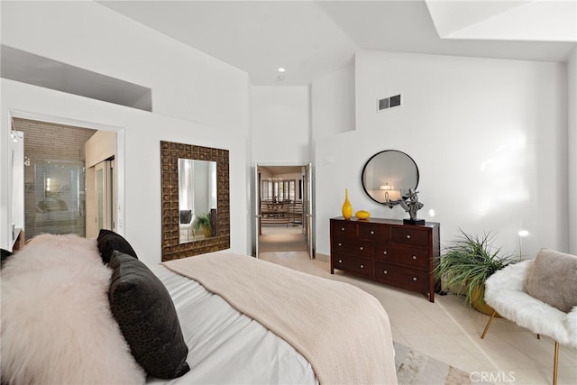 bedroom with high vaulted ceiling and visible vents