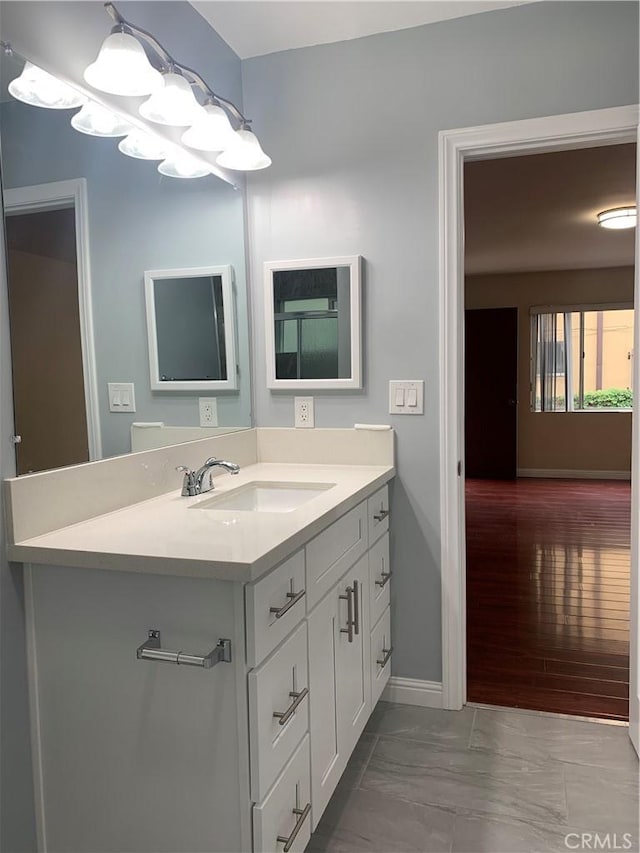 bathroom with vanity and baseboards