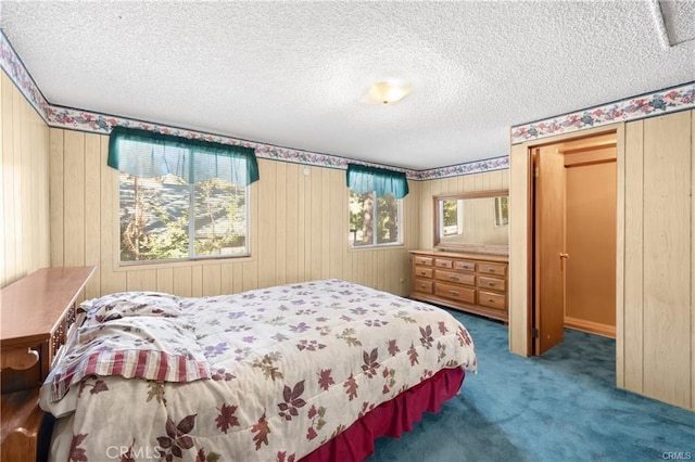 5768 Heath Creek Dr, Wrightwood, CA 92397 - bedroom featuring wood walls, carpet flooring, and a textured ceiling