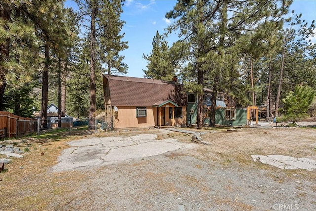 5768 Heath Creek Dr, Wrightwood, CA 92397 - view of front of property featuring a gambrel roof, roof with shingles, and fence