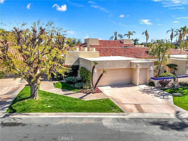232 Kavenish Dr W, Rancho Mirage, CA 92270 - mediterranean / spanish-style home featuring an attached garage, concrete driveway, a tiled roof, and stucco siding