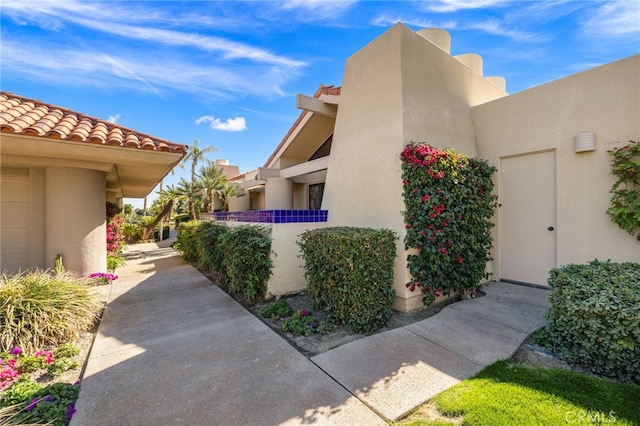 view of home's exterior featuring a tiled roof and stucco siding