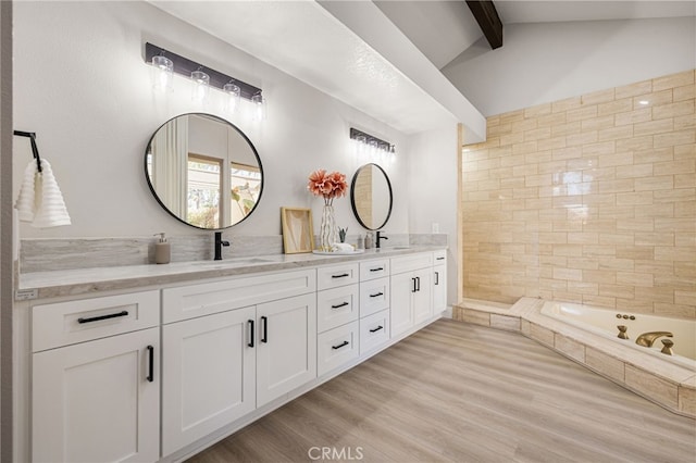 232 Kavenish Dr W, Rancho Mirage, CA 92270 - bathroom featuring lofted ceiling with beams, wood finished floors, a sink, and double vanity
