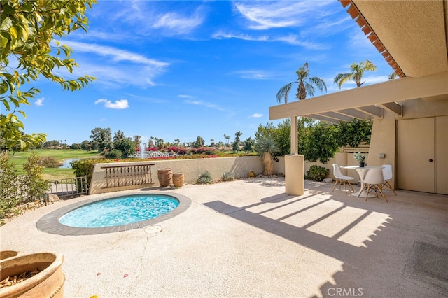 232 Kavenish Dr W, Rancho Mirage, CA 92270 - view of pool featuring fence, a water view, a patio area, and a swimming pool
