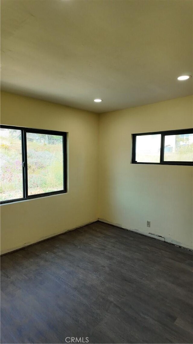 unfurnished room with recessed lighting and dark wood finished floors
