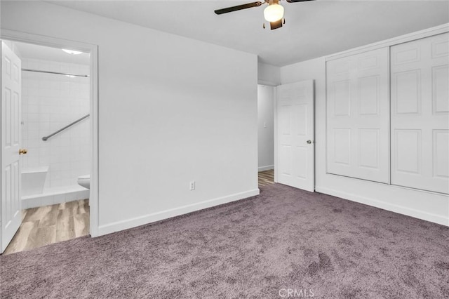 unfurnished bedroom with ceiling fan, connected bathroom, baseboards, a closet, and dark carpet