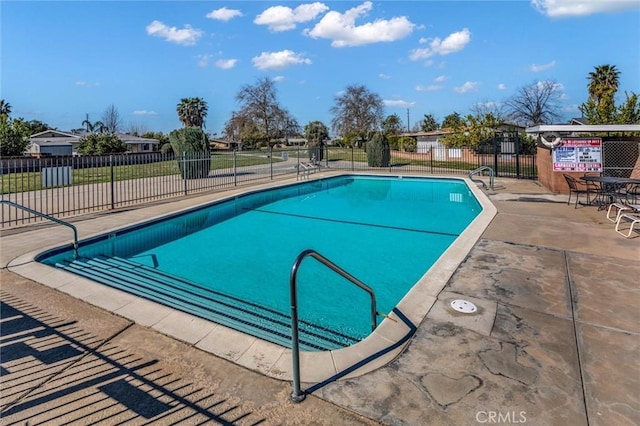 pool featuring fence and a patio